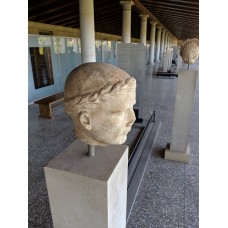 Portrait head of boy initiate wearing myrtle wreath